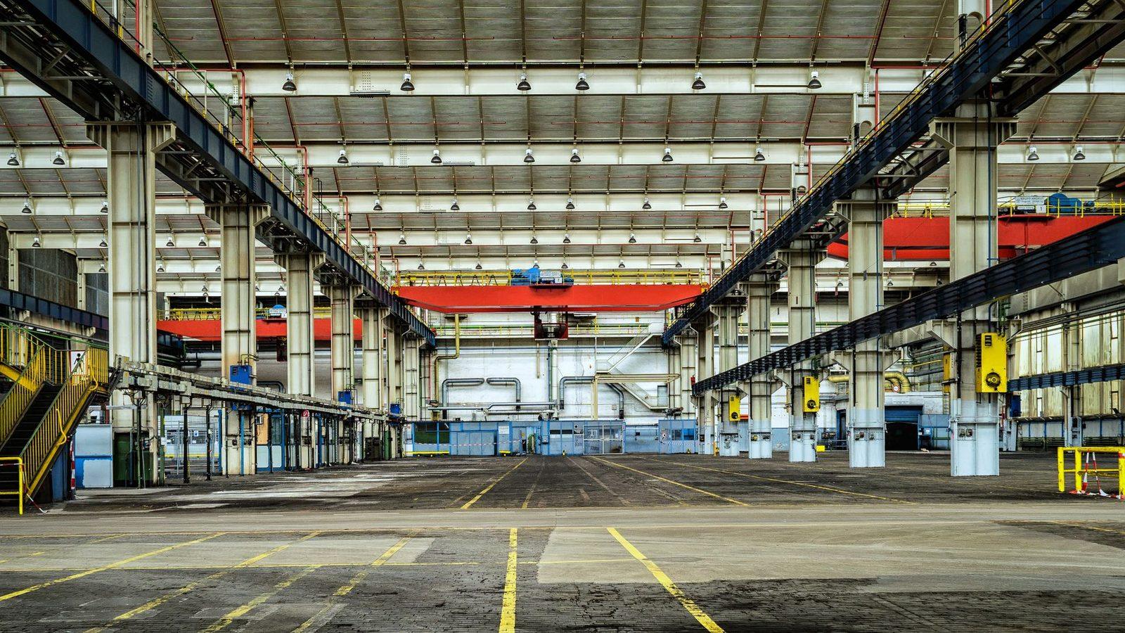 Empty industrial hall with idle overhead cranes
